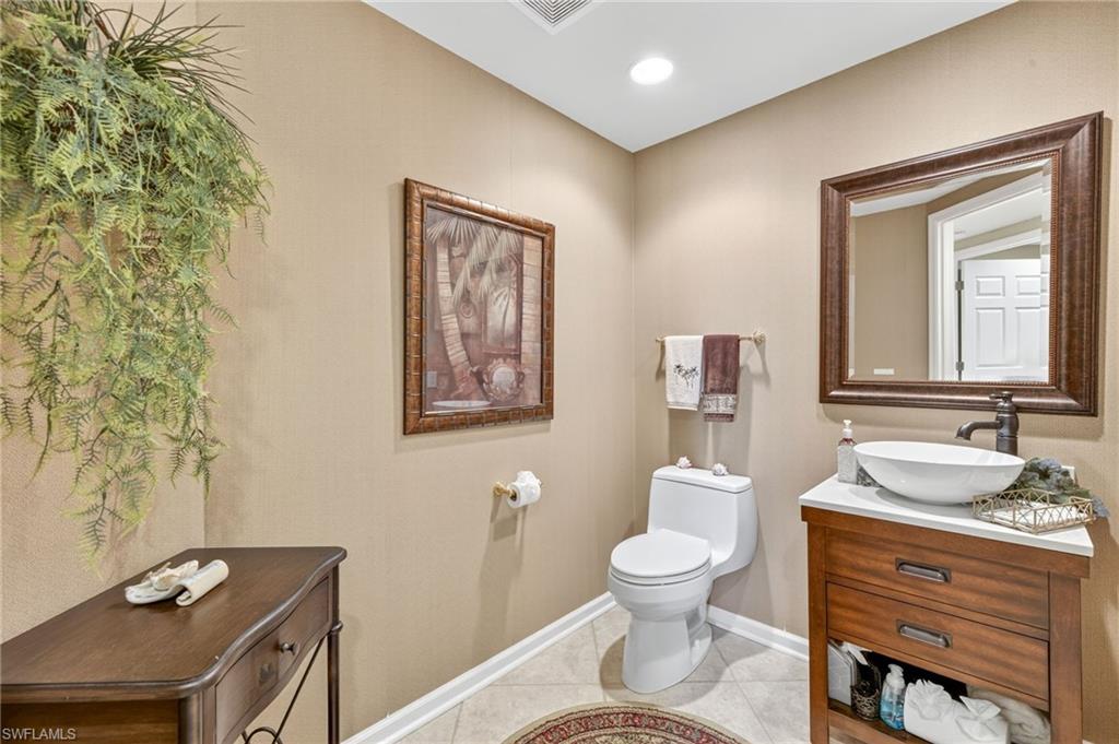 Bathroom with vanity, light tile patterned flooring, and recessed lighting