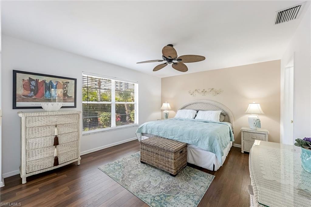 Bedroom with dark wood-type flooring and a ceiling fan