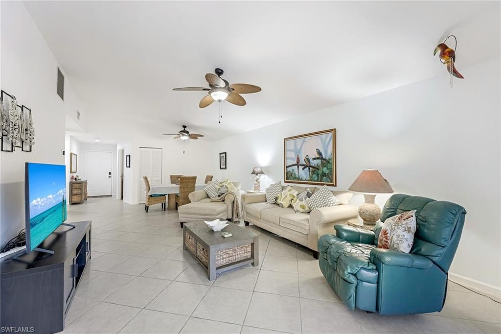 Living area with light tile patterned flooring and a ceiling fan
