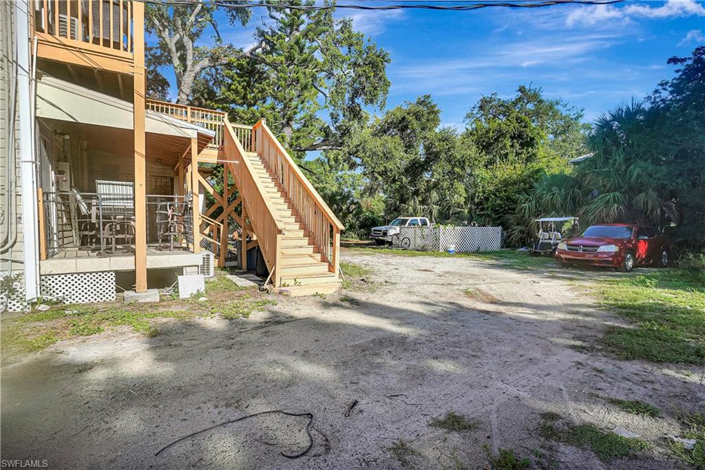 View of yard with stairs and a wooden deck