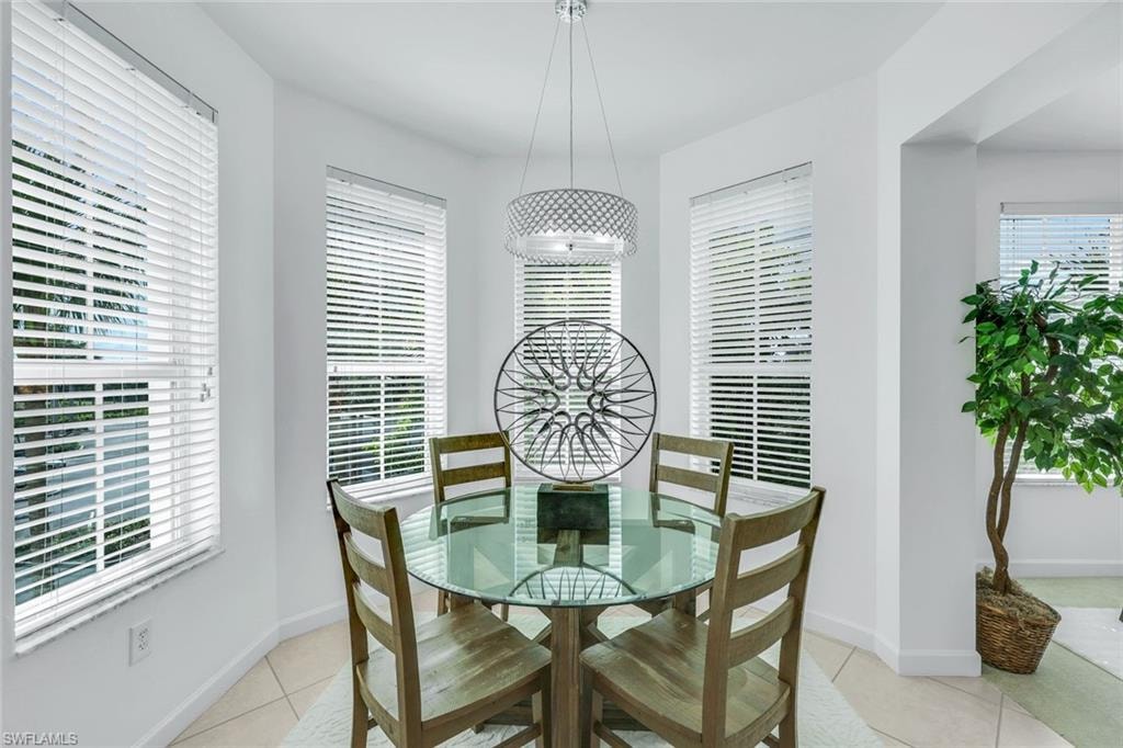 Dining space featuring light tile patterned flooring and baseboards