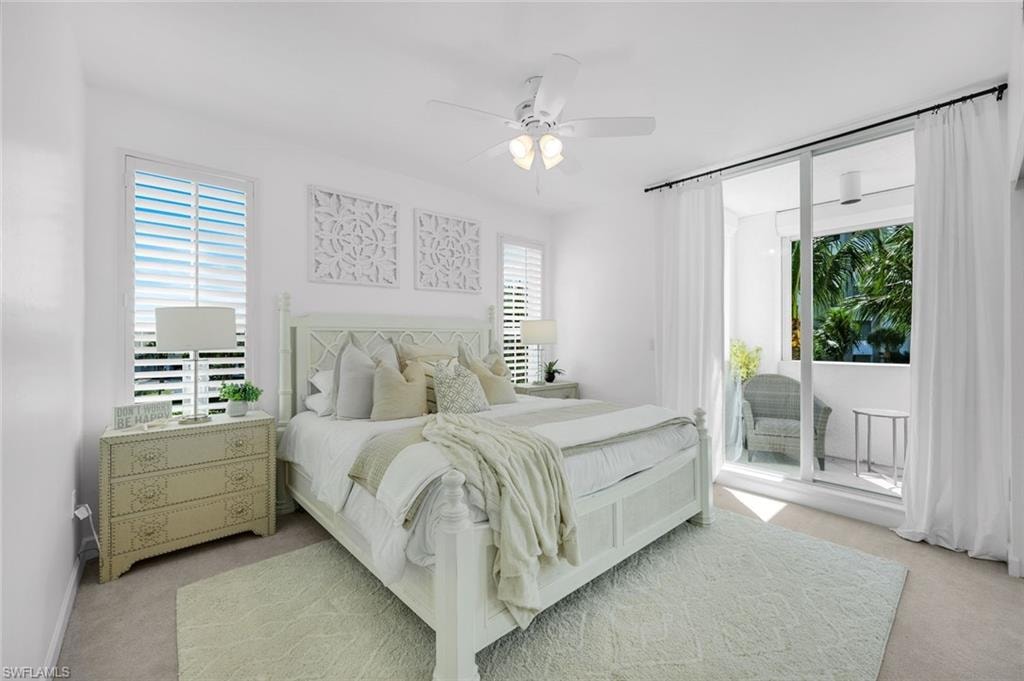 Bedroom featuring light colored carpet, a ceiling fan, and access to outside