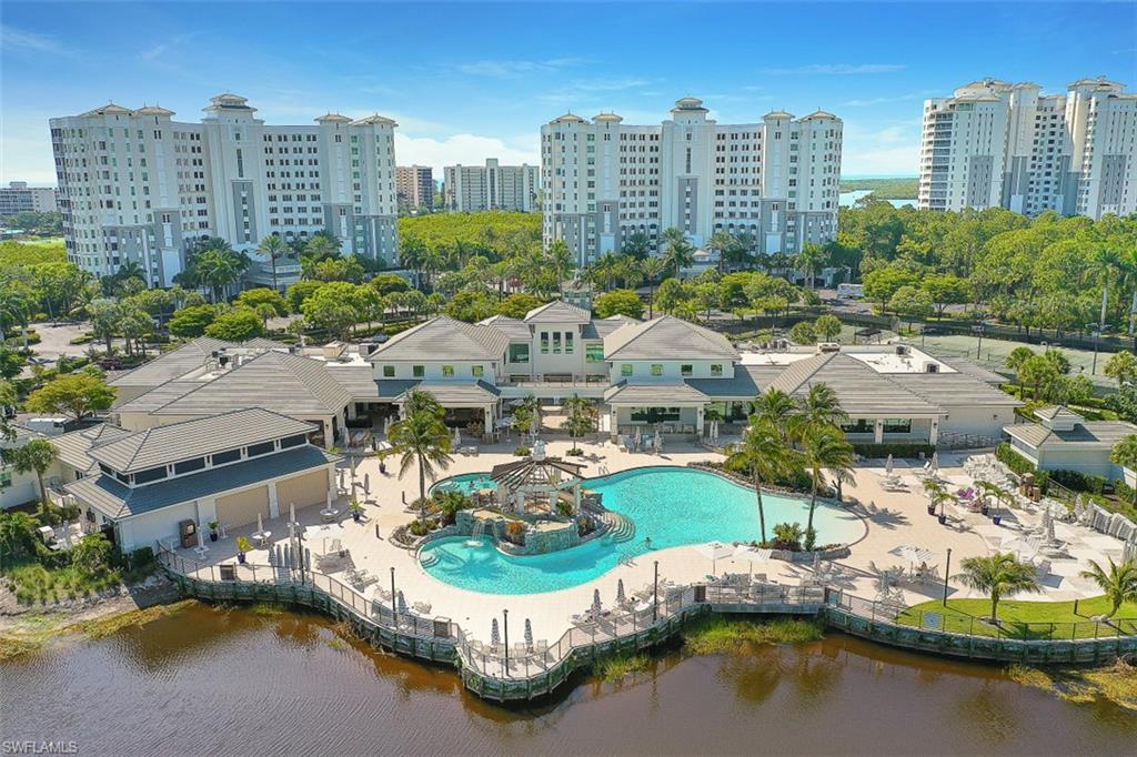 View of urban area with a pool and a nearby body of water