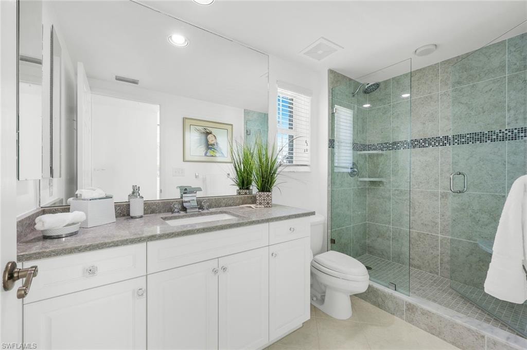 Full bathroom with a shower stall, vanity, light tile patterned floors, and recessed lighting
