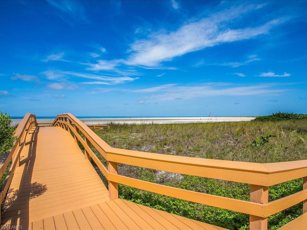 Surrounding community with view of water and beach