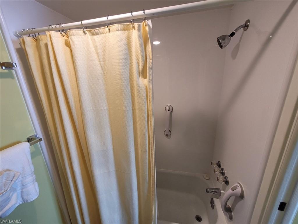 Bathroom with shower / tub combo with curtain