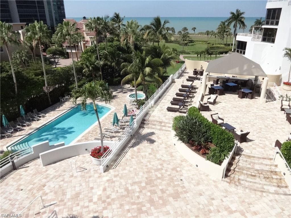Community pool with a patio area and a water view