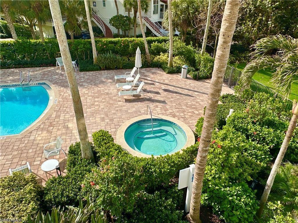 Community pool featuring a patio, a community hot tub, and stairway