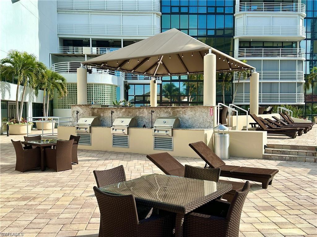 View of patio featuring outdoor dining space and an outdoor kitchen