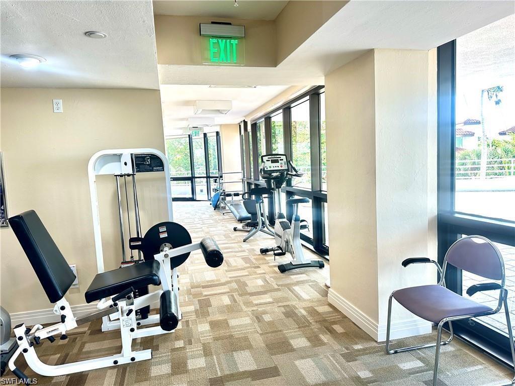 Workout area with carpet floors and floor to ceiling windows
