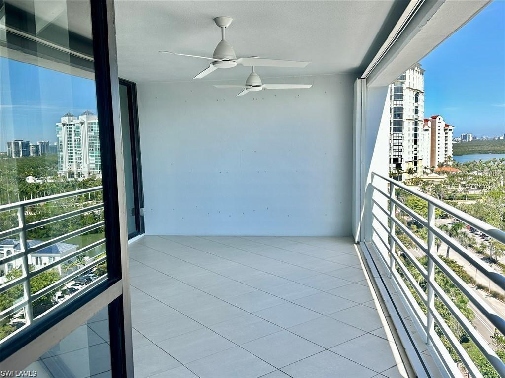 Balcony featuring a view of city and ceiling fan