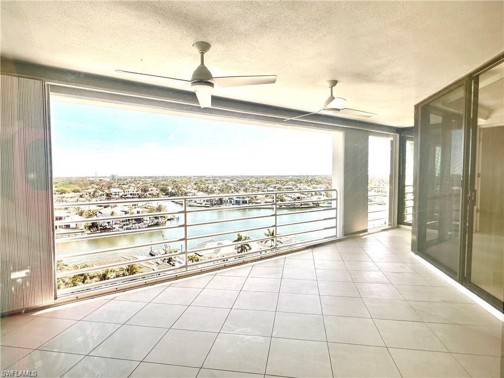 Balcony with a water view and ceiling fan