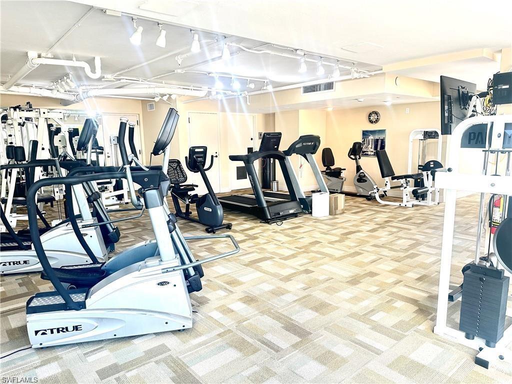 Gym with light colored carpet and track lighting