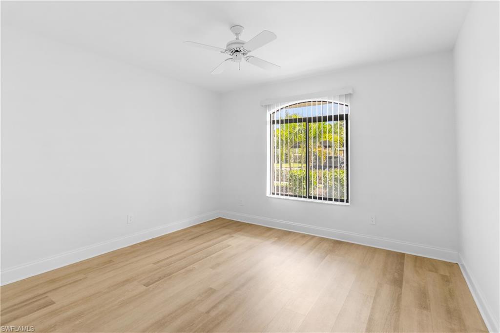 Empty room with light wood-style floors and a ceiling fan