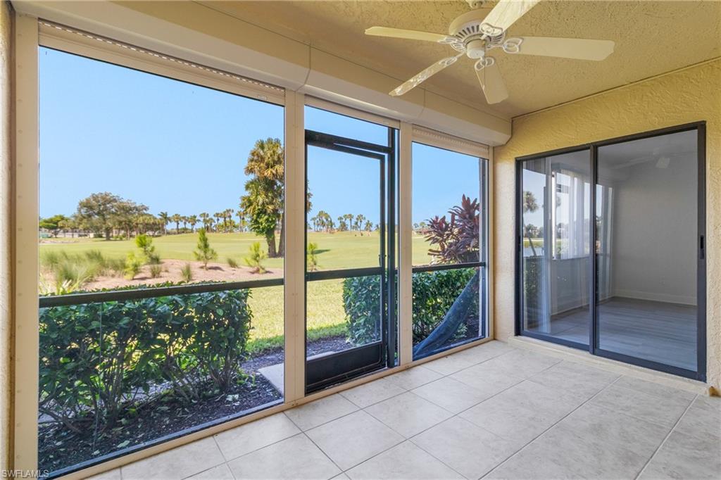 Unfurnished sunroom featuring ceiling fan and view of golf course