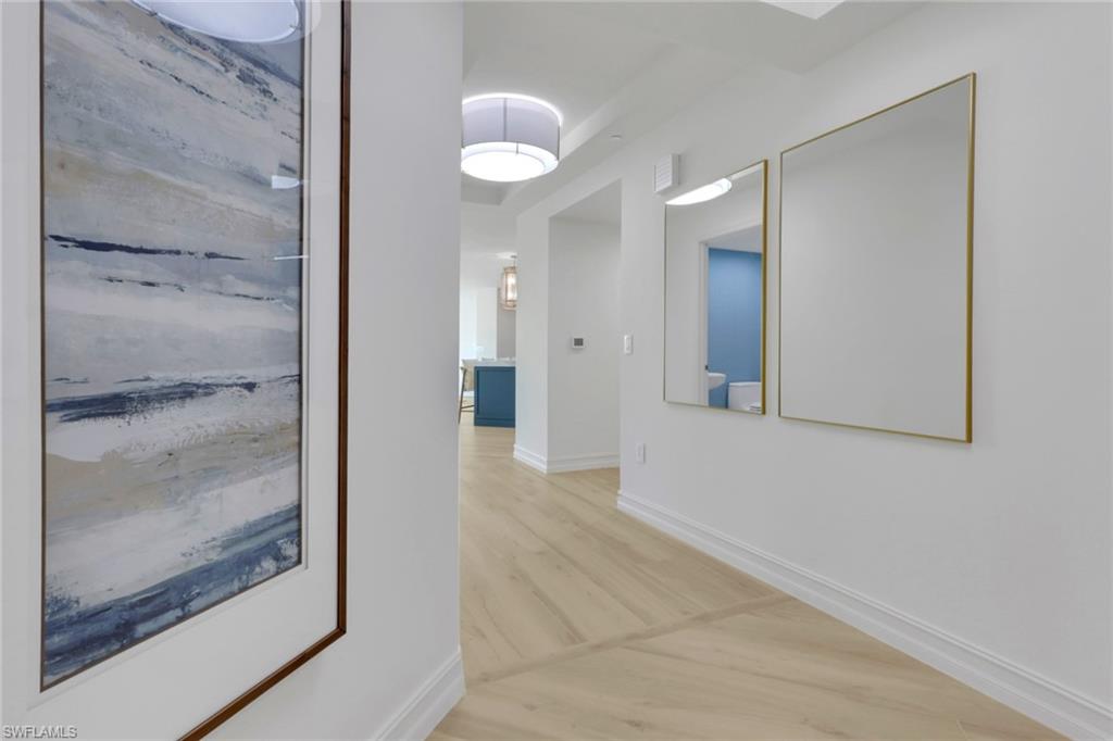 Hall featuring light wood-style flooring and baseboards