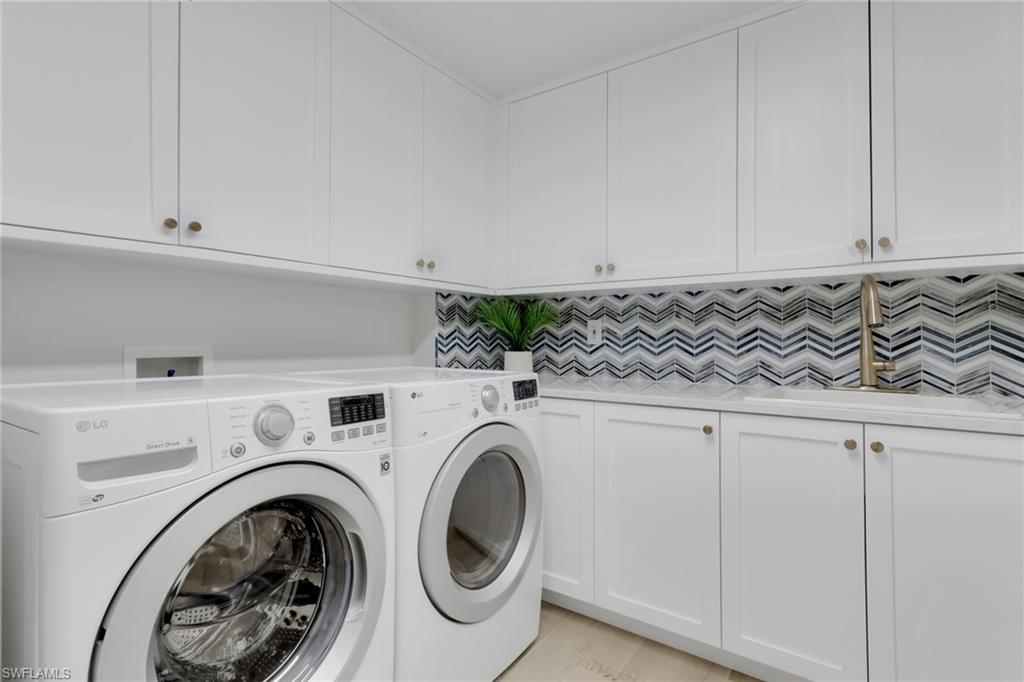 Laundry area with cabinet space and independent washer and dryer