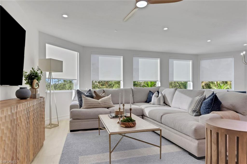 Living area with recessed lighting and a ceiling fan