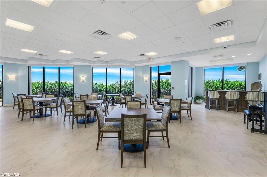 Dining area featuring light marble finish floors and a drop ceiling
