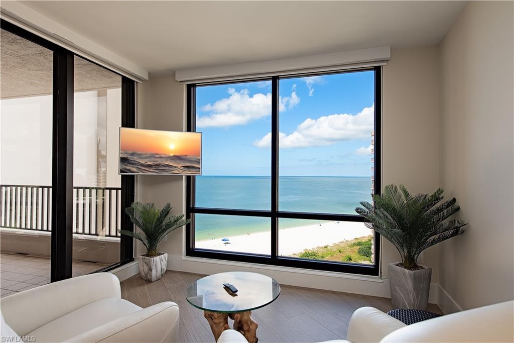 Den with a dramatic crescent beach view