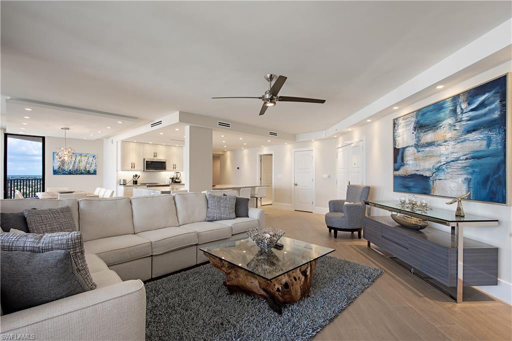 Living area featuring light wood-style flooring, a chandelier, recessed lighting, and a ceiling fan.