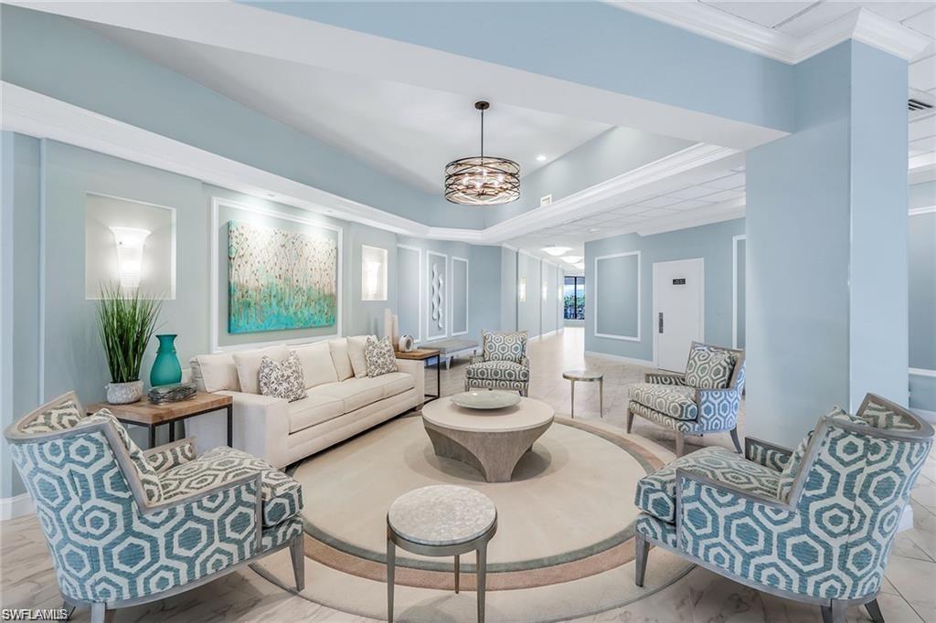 1st floor Sitting room with a chandelier, a raised ceiling, and ornamental molding