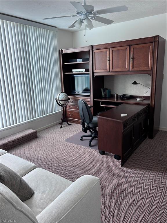 Office featuring a ceiling fan and carpet