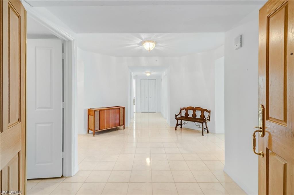 Hall featuring light tile patterned flooring