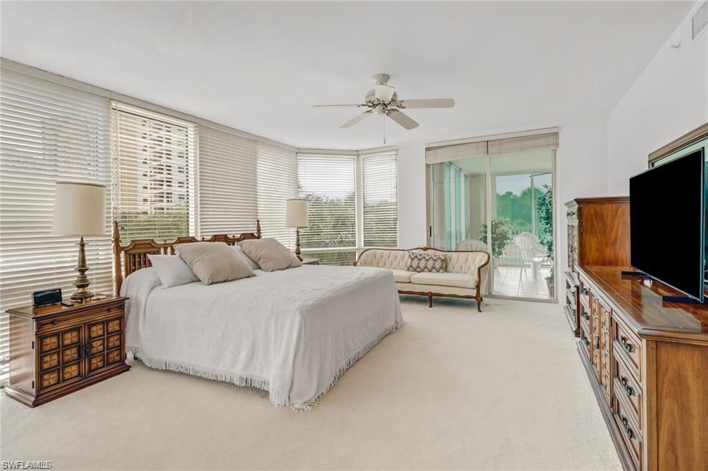 Bedroom featuring light carpet, access to exterior, and a ceiling fan