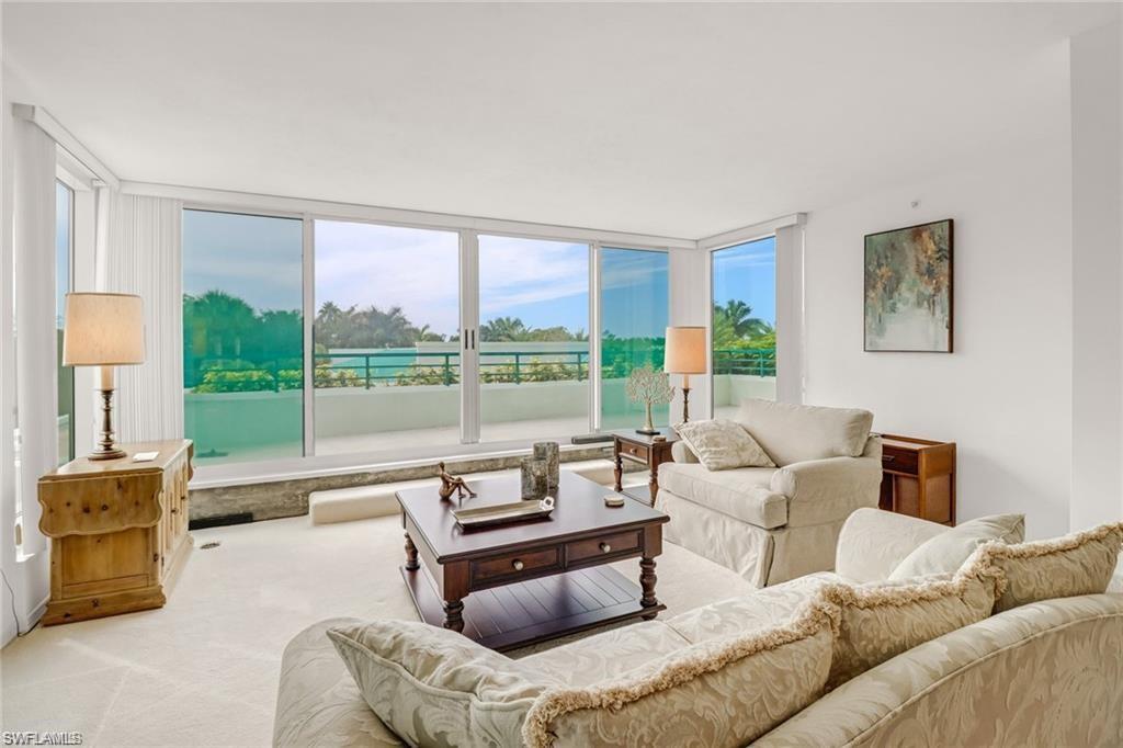 Living room featuring expansive windows and carpet floors