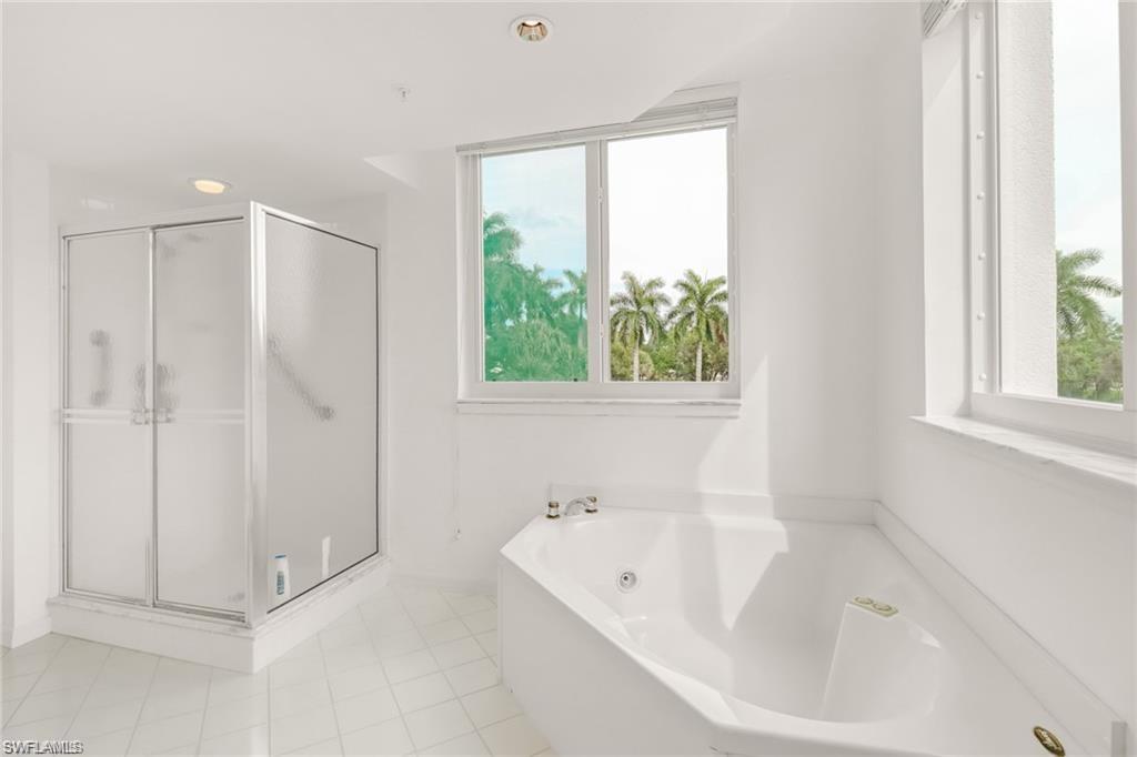 Full bath with a garden tub, a shower stall, light tile patterned flooring, and recessed lighting