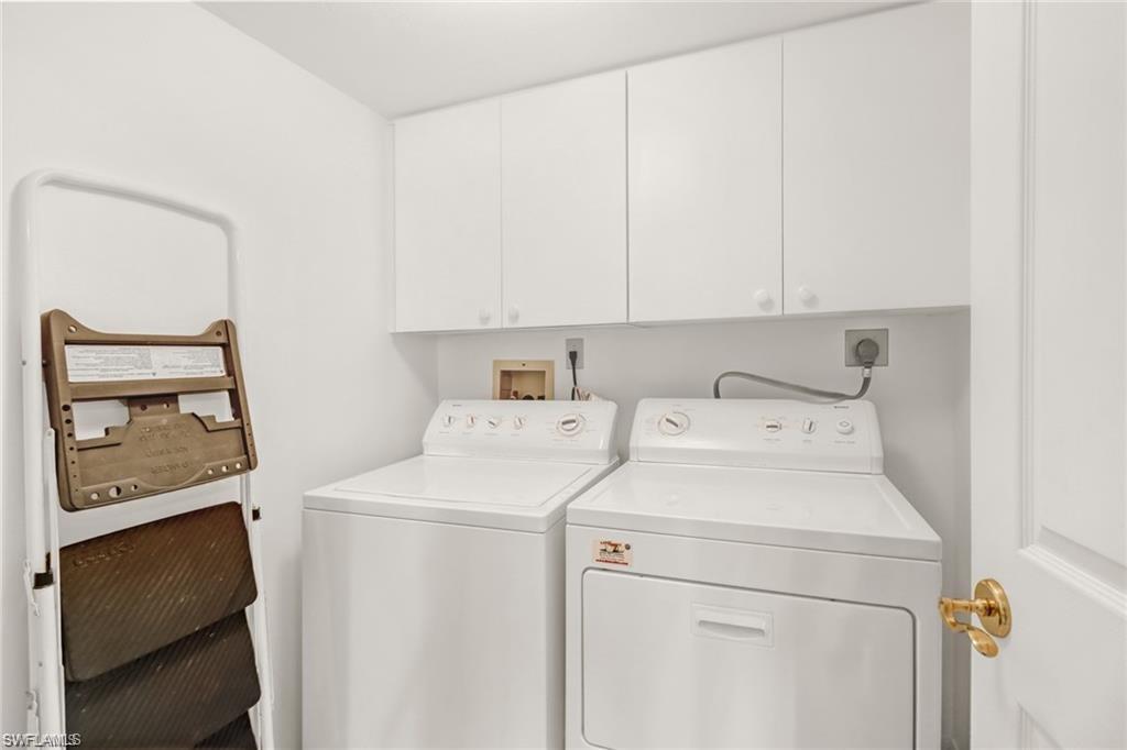 Laundry room with independent washer and dryer and cabinet space