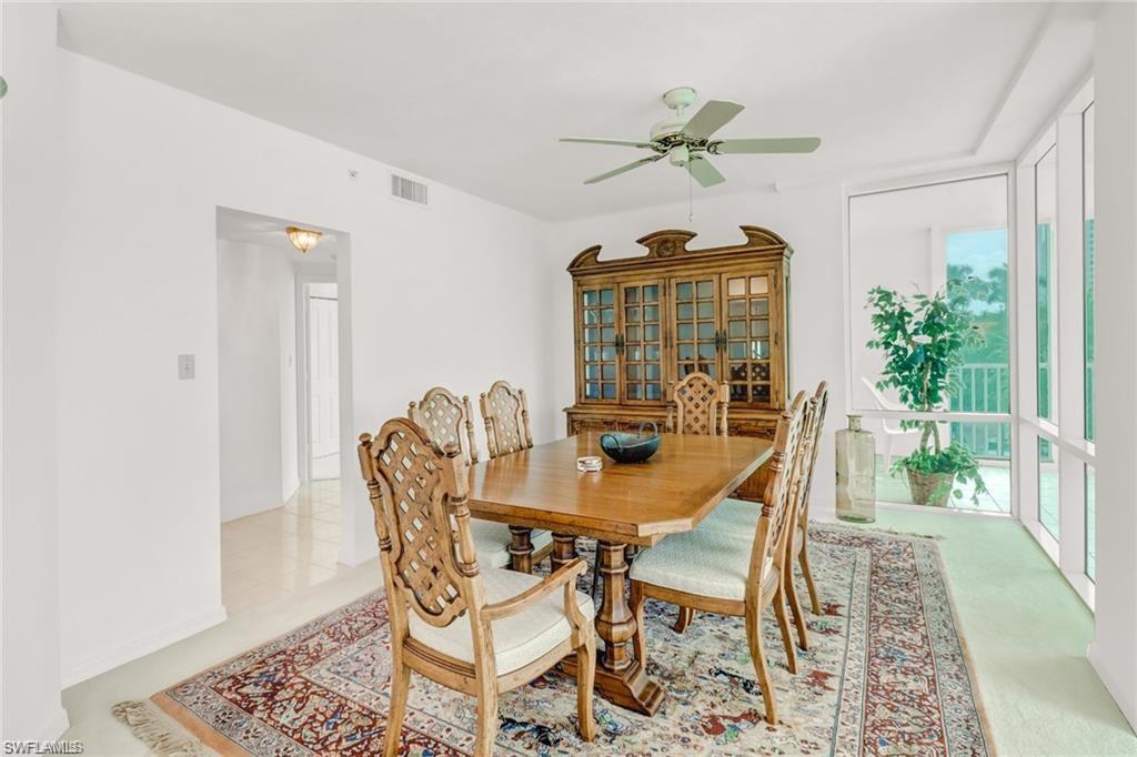 Dining area featuring floor to ceiling windows and a ceiling fan