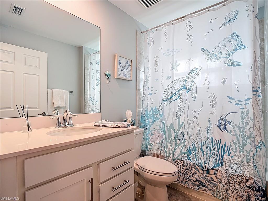 Full bath featuring vanity and shower / bathtub combination with curtain