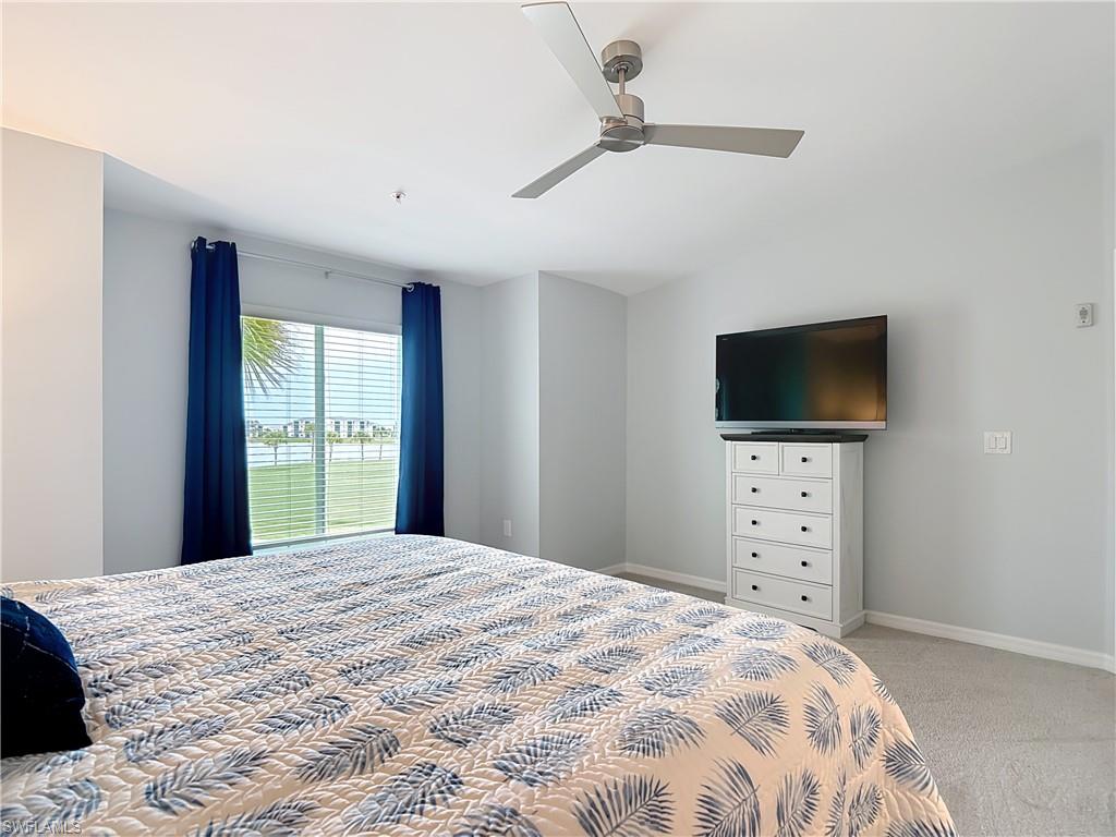 Bedroom featuring light colored carpet and a ceiling fan
