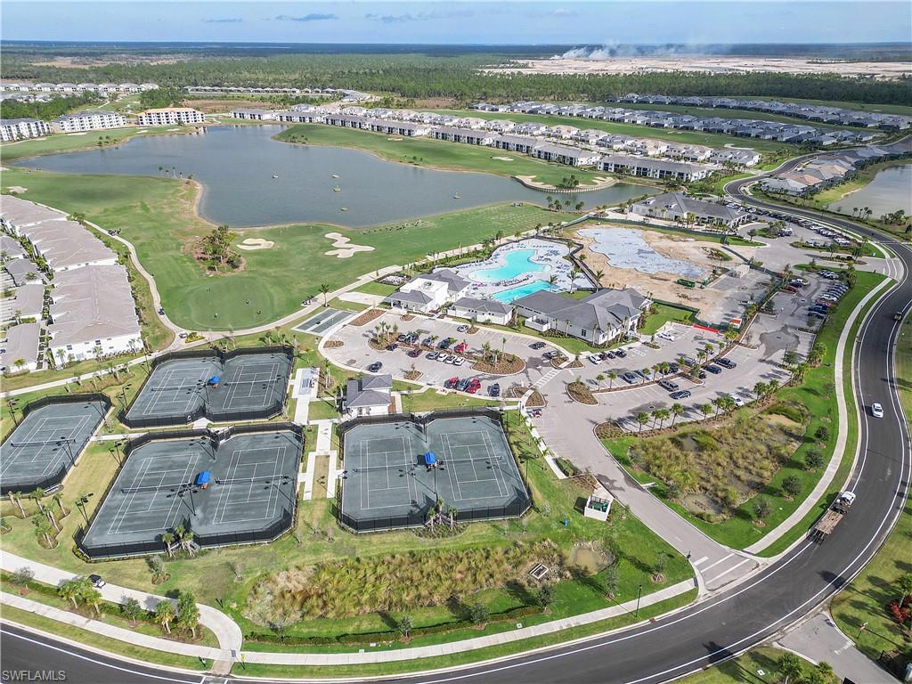 Aerial overview of property's location with a nearby body of water and a golf course