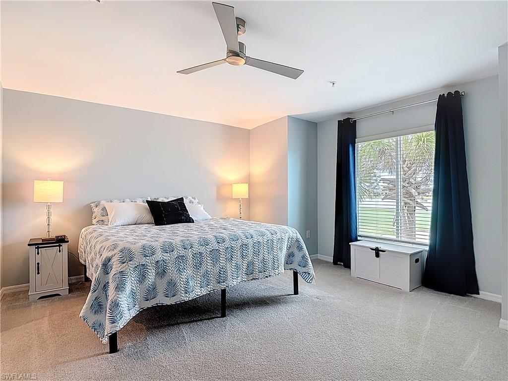 Bedroom with light colored carpet and ceiling fan