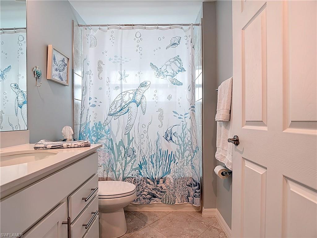 Bathroom with vanity and light tile patterned flooring