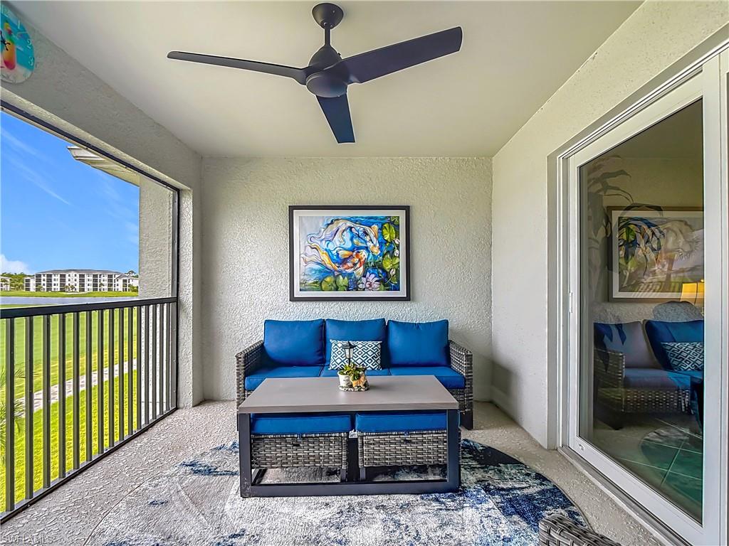 Sunroom featuring an outdoor living space, a ceiling fan, and a balcony