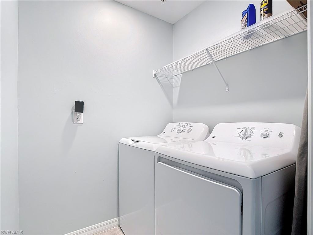 Laundry room featuring baseboards and separate washer and dryer