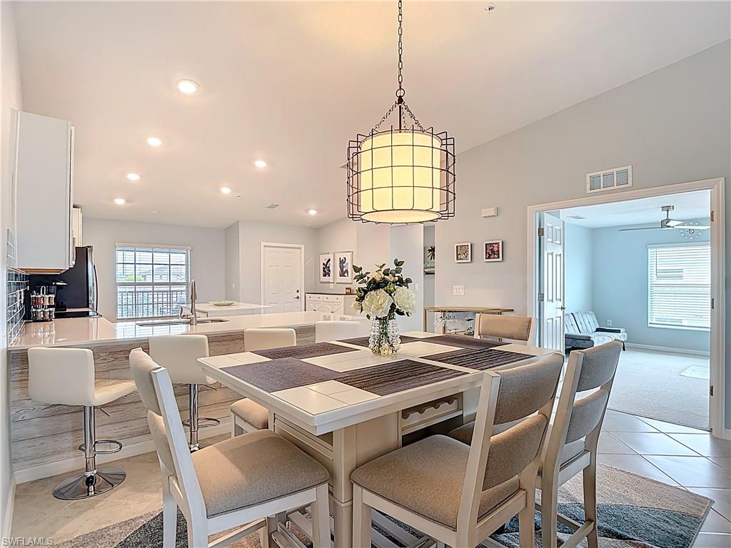 Dining room with recessed lighting, light tile patterned floors, and a ceiling fan