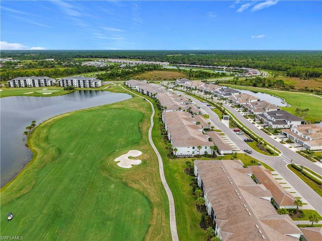 Aerial view of residential area with a golf course and a large body of water
