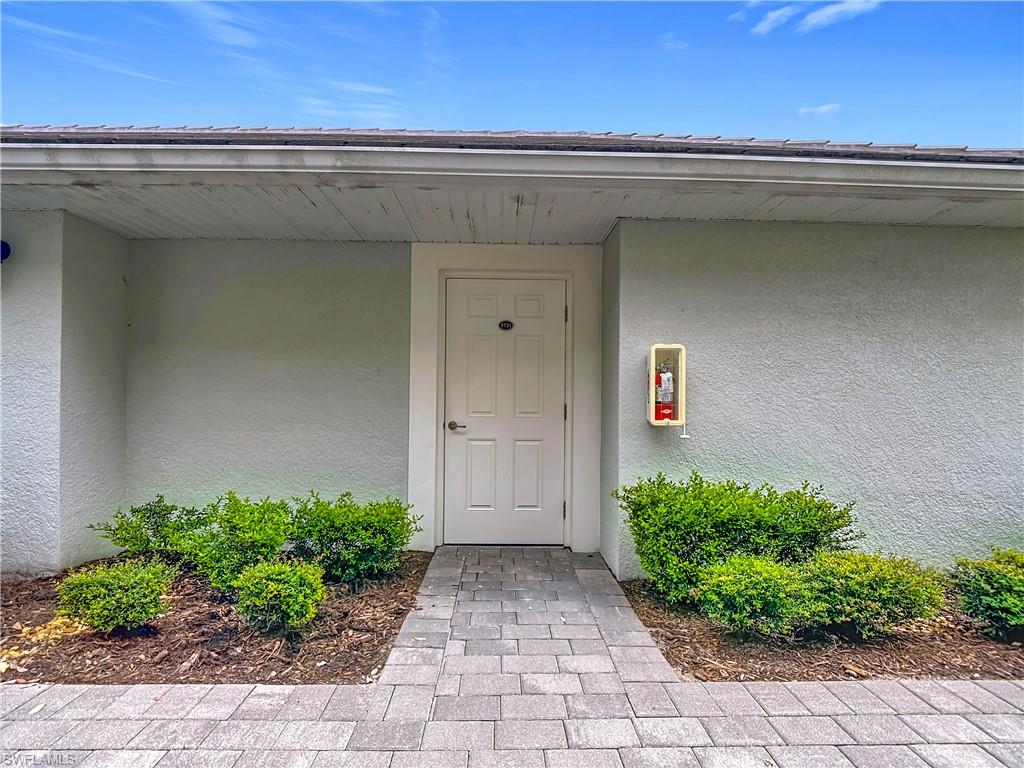 Entrance to property featuring stucco siding