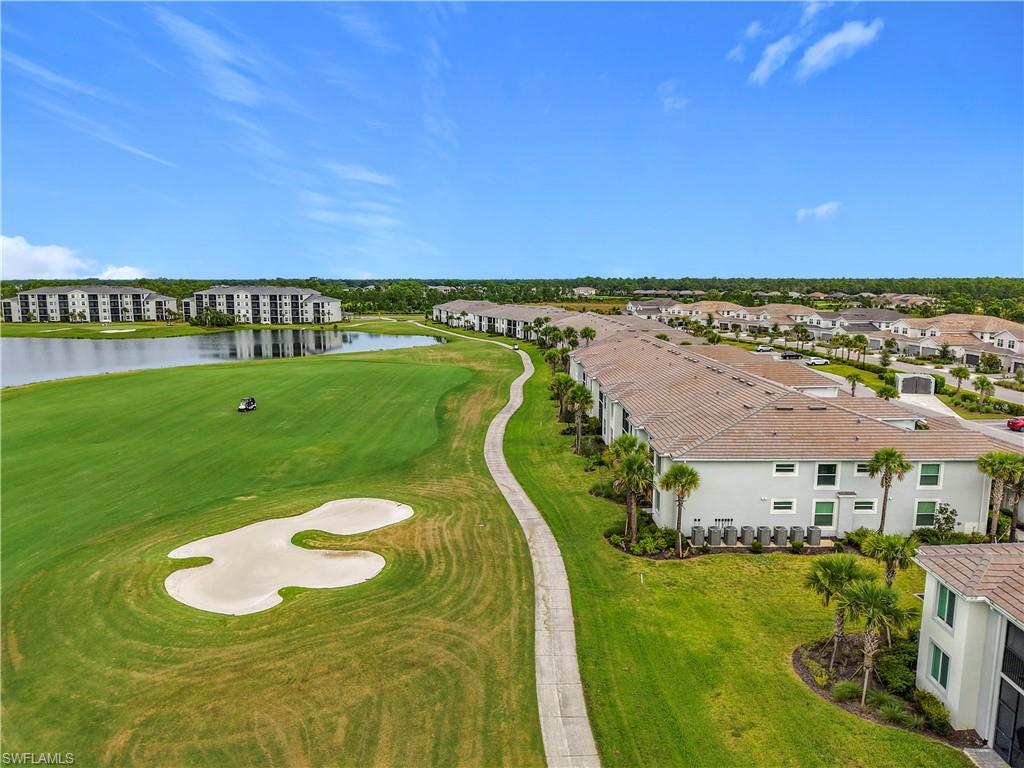 Bird's eye view of a golf course and a nearby body of water