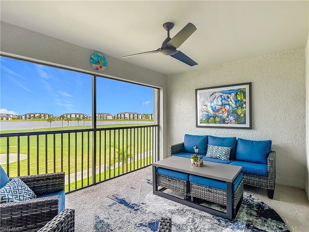 Sunroom / solarium featuring a water view