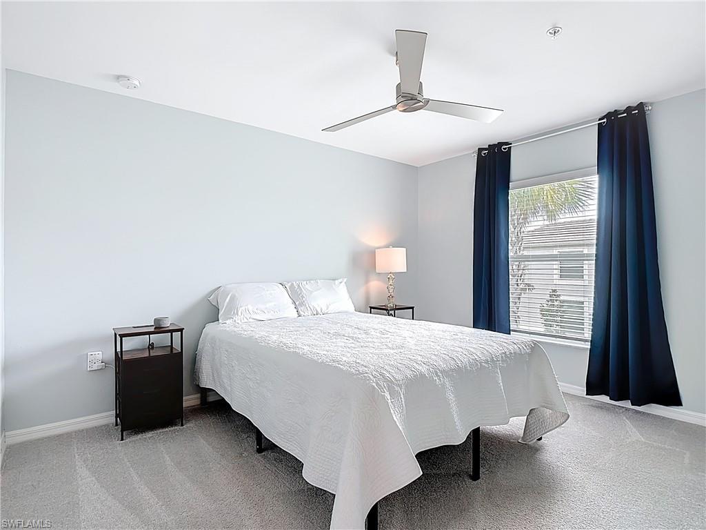 Bedroom featuring light colored carpet and a ceiling fan