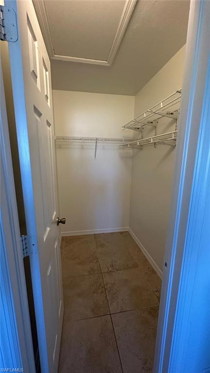 Spacious closet featuring light tile patterned flooring