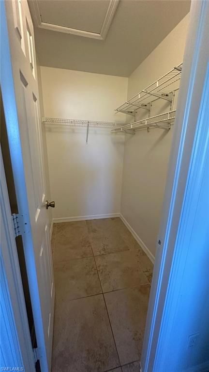 Walk in closet featuring light tile patterned flooring