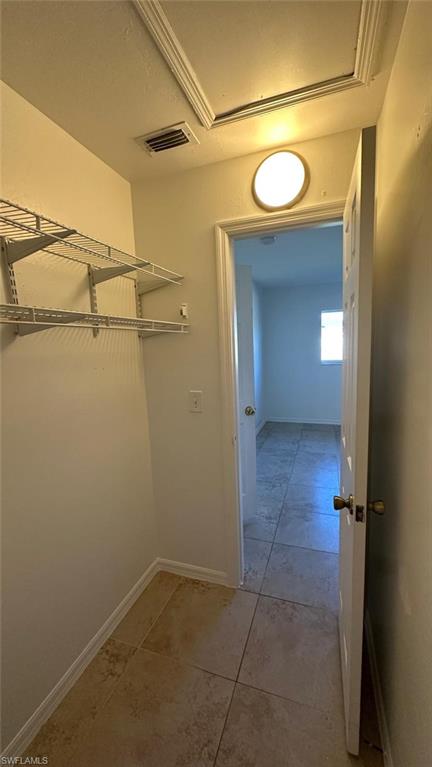 Spacious closet featuring light tile patterned floors