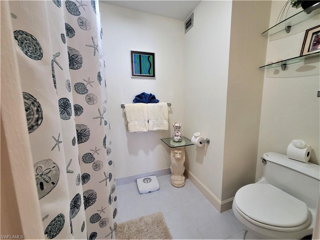 Full bath featuring tile patterned flooring and a stall shower